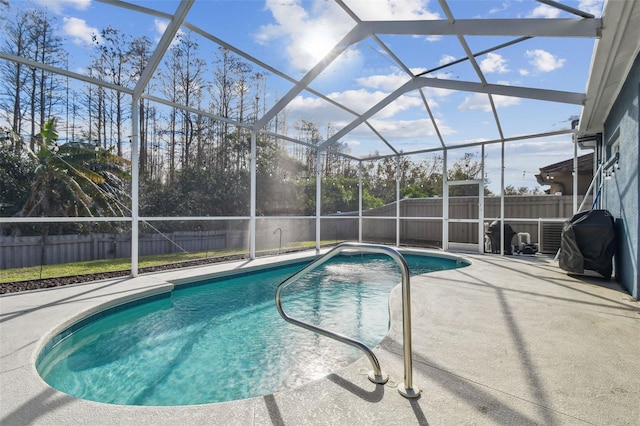 view of swimming pool featuring area for grilling, a lanai, and a patio area