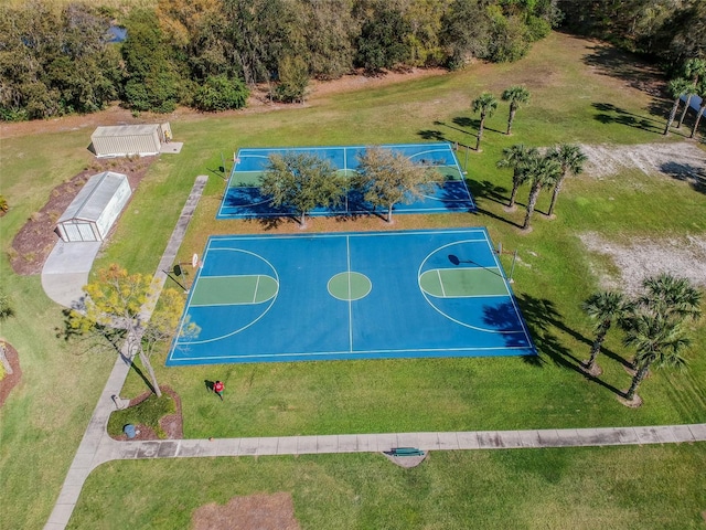 view of sport court featuring a lawn