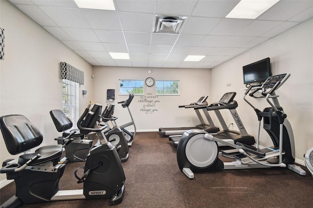 exercise room with a paneled ceiling