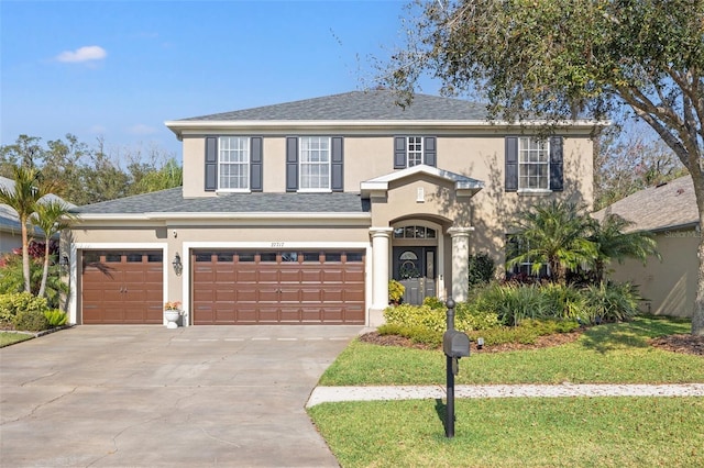 view of front property featuring a garage and a front yard