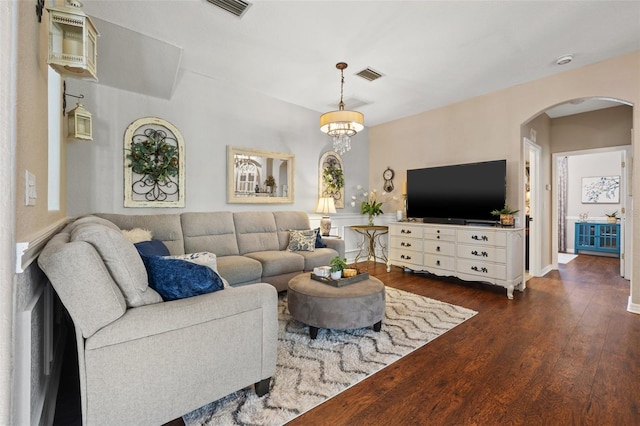 living room featuring dark hardwood / wood-style floors and a chandelier