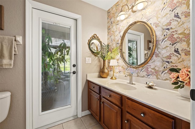 bathroom featuring vanity, tile patterned floors, and toilet