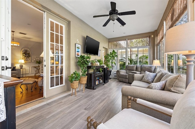 sunroom / solarium featuring ceiling fan