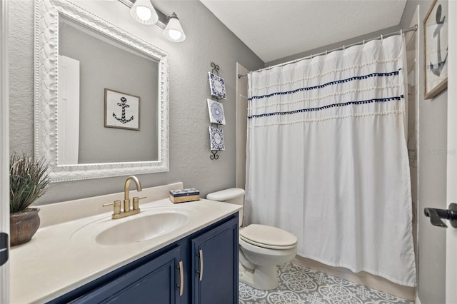 bathroom featuring vanity, toilet, a shower with shower curtain, and a textured ceiling