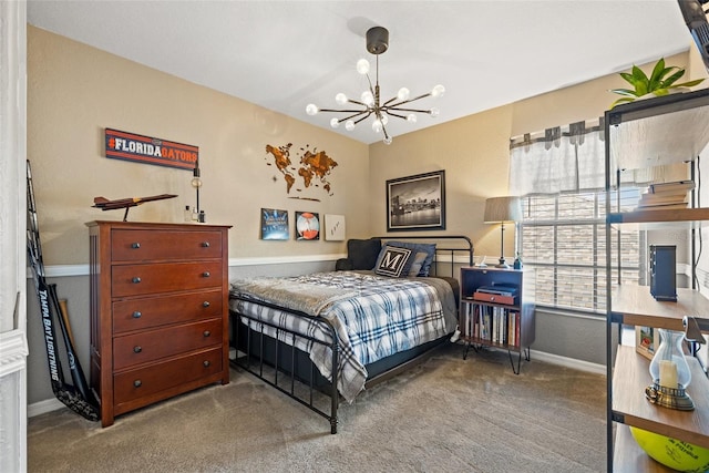 bedroom featuring an inviting chandelier and carpet floors