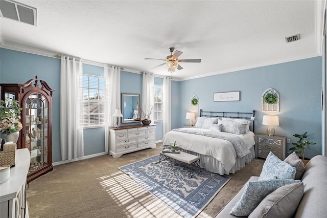 bedroom featuring crown molding, light colored carpet, ceiling fan, and a textured ceiling