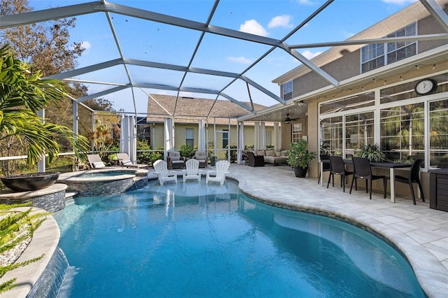 view of swimming pool featuring an in ground hot tub, ceiling fan, glass enclosure, and a patio