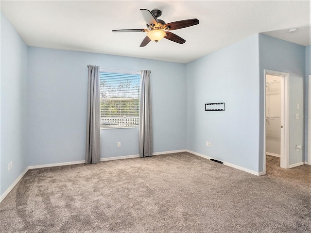 unfurnished room featuring ceiling fan and carpet flooring