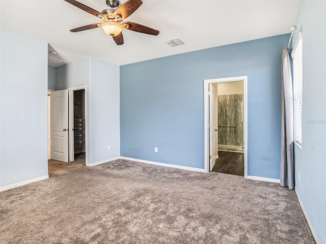 unfurnished bedroom with carpet, connected bathroom, and ceiling fan