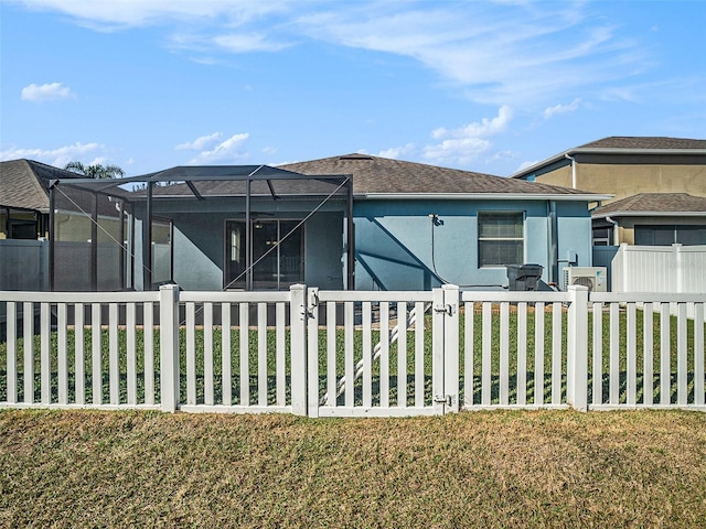 view of front of house with a lanai and a front yard