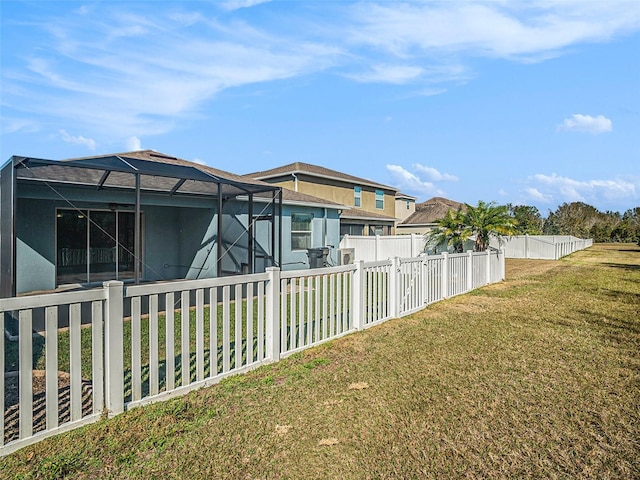 view of yard with glass enclosure