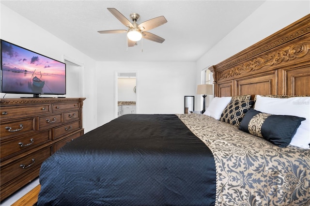 bedroom with ceiling fan and ensuite bath