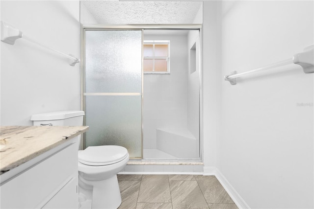 bathroom with vanity, an enclosed shower, a textured ceiling, and toilet