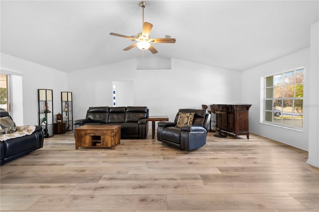 living room with ceiling fan, lofted ceiling, and light hardwood / wood-style floors