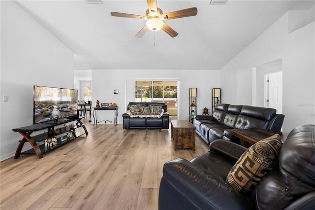 living room with ceiling fan, high vaulted ceiling, and light hardwood / wood-style floors