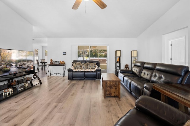 living room with lofted ceiling, ceiling fan, and light hardwood / wood-style flooring