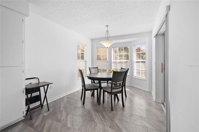 dining space featuring a textured ceiling