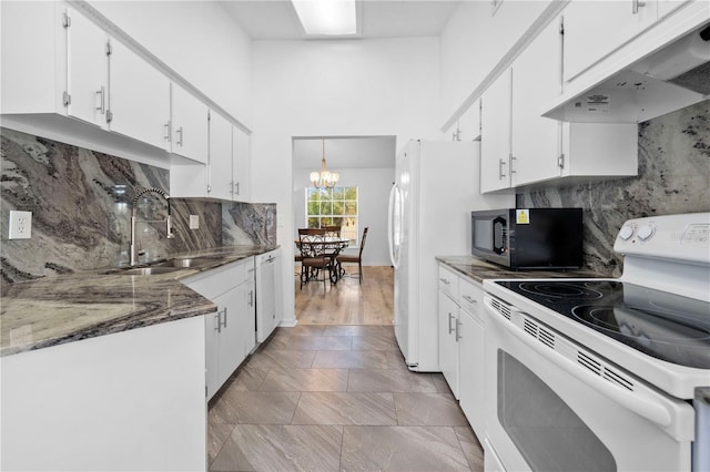 kitchen with pendant lighting, white appliances, sink, and white cabinets