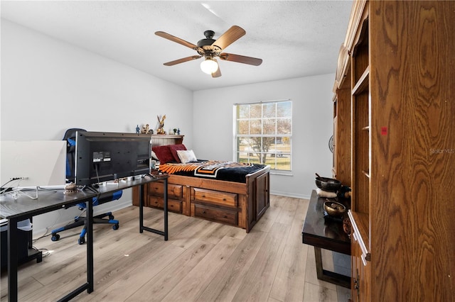 office featuring a textured ceiling, light hardwood / wood-style floors, and ceiling fan