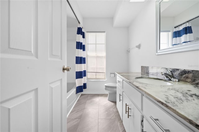 full bathroom with vanity, shower / tub combo, and toilet