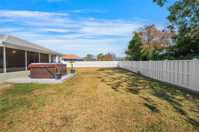 view of yard with a hot tub and a patio area