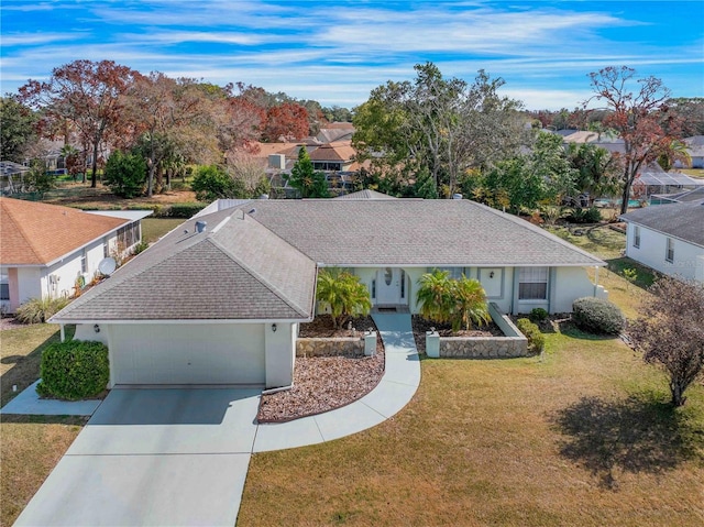 ranch-style home featuring a garage and a front lawn