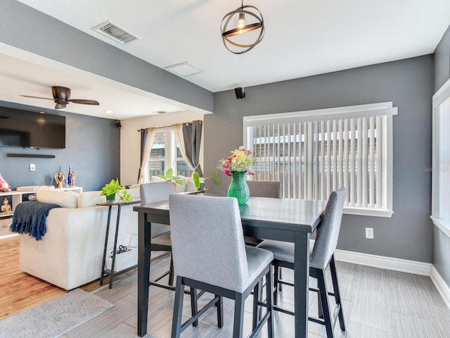 dining room with hardwood / wood-style floors and ceiling fan