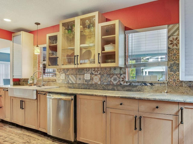 kitchen with tasteful backsplash, dishwasher, hanging light fixtures, light hardwood / wood-style floors, and light brown cabinets