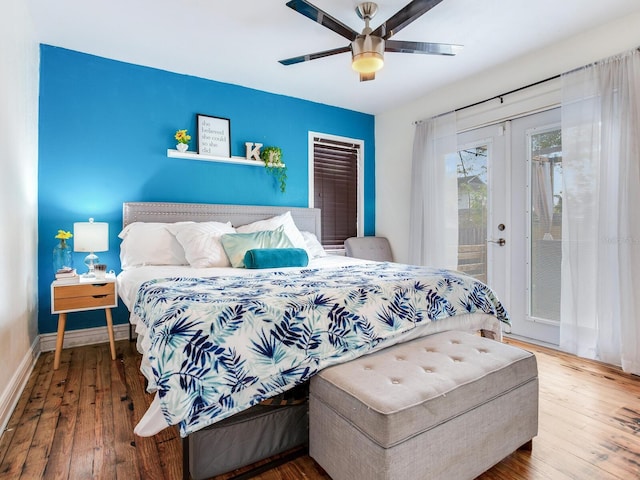 bedroom featuring hardwood / wood-style flooring, ceiling fan, french doors, and access to outside