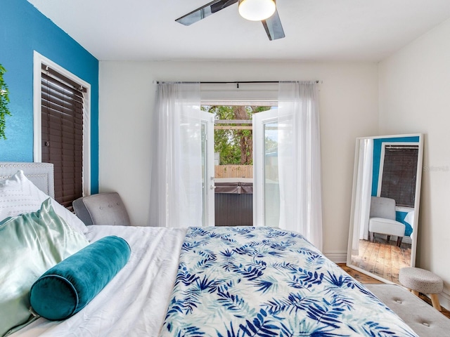 bedroom featuring ceiling fan, access to exterior, and hardwood / wood-style floors