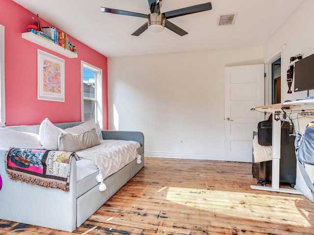 living room with ceiling fan and light wood-type flooring