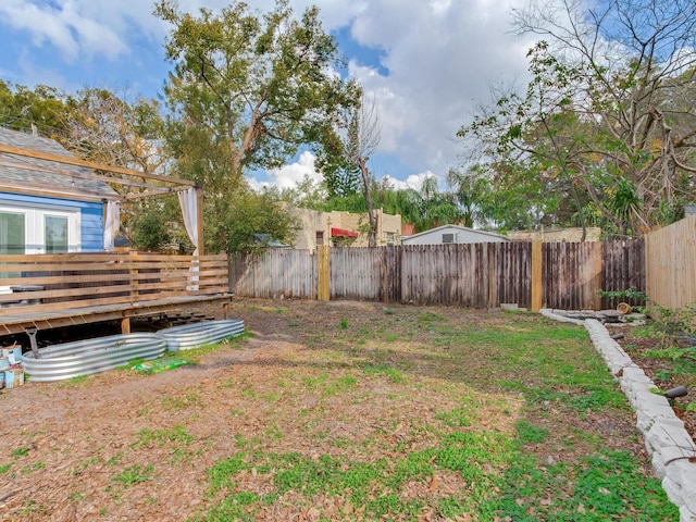 view of yard featuring a wooden deck