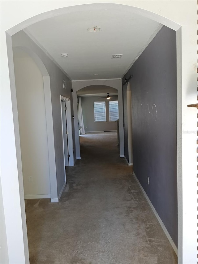 corridor with crown molding and carpet flooring