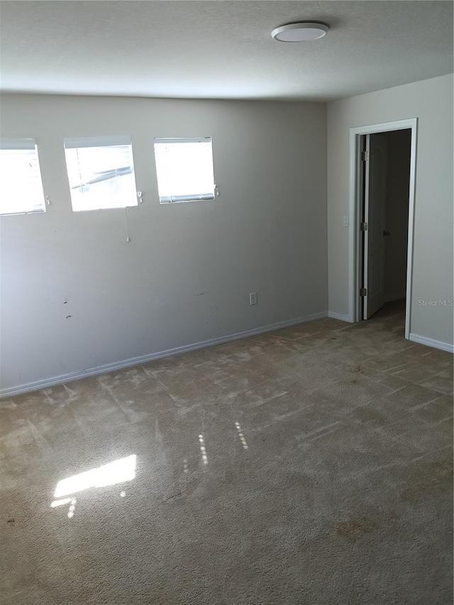 unfurnished room featuring dark carpet