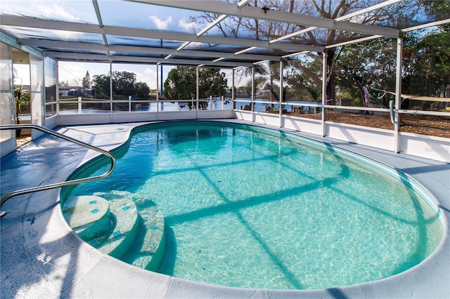 view of pool featuring glass enclosure