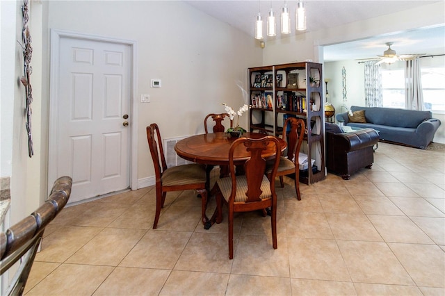 tiled dining room with lofted ceiling and ceiling fan