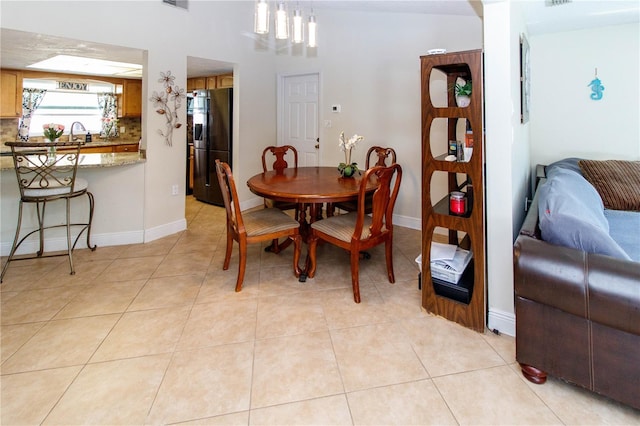 dining area featuring light tile patterned floors and sink