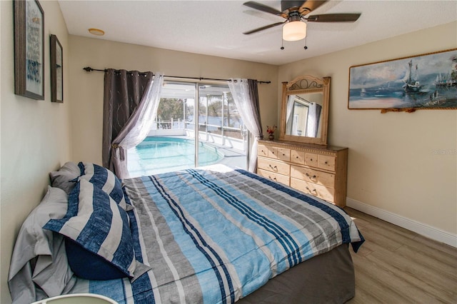 bedroom with hardwood / wood-style flooring, ceiling fan, and access to exterior