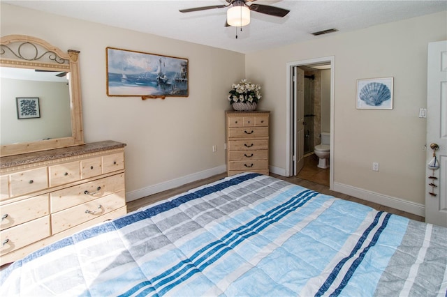 unfurnished bedroom featuring ceiling fan, hardwood / wood-style floors, and ensuite bath