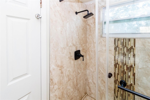 interior details featuring a tile shower