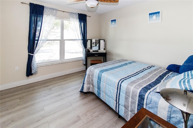 bedroom with light hardwood / wood-style floors and ceiling fan