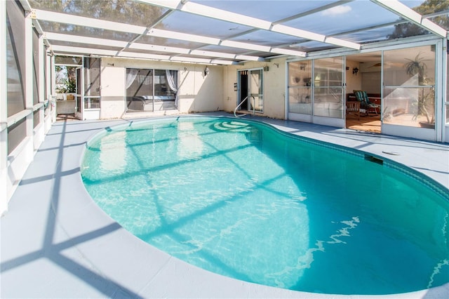 view of swimming pool with a patio area and glass enclosure