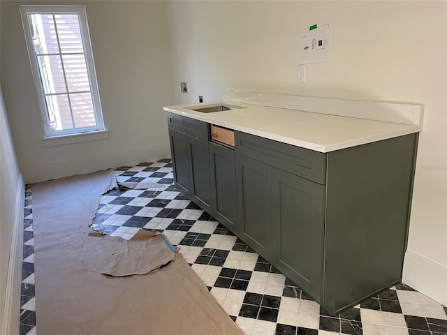 interior space with light countertops and a sink