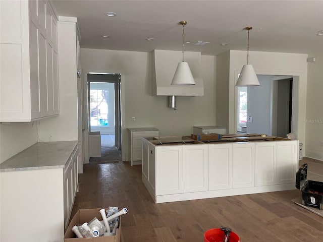 kitchen featuring white cabinetry, decorative light fixtures, dark wood-style flooring, and a wealth of natural light