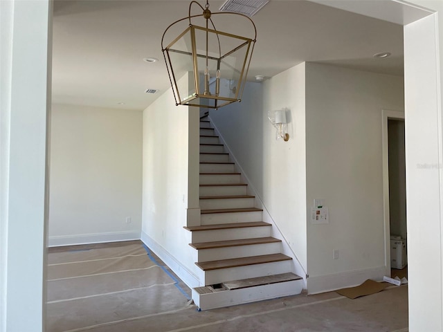 stairs featuring visible vents, recessed lighting, concrete floors, and baseboards