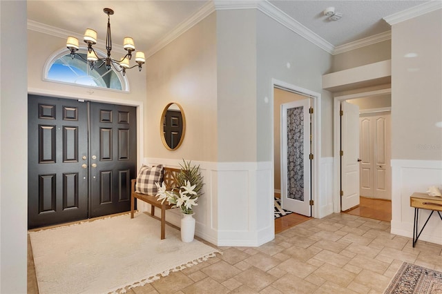 entrance foyer with an inviting chandelier and ornamental molding