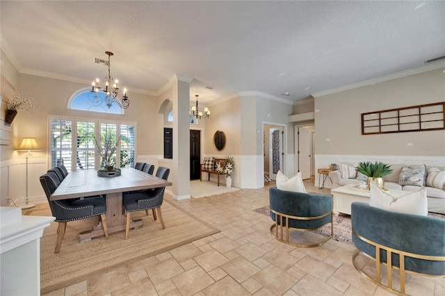 dining space featuring crown molding, a textured ceiling, and a notable chandelier