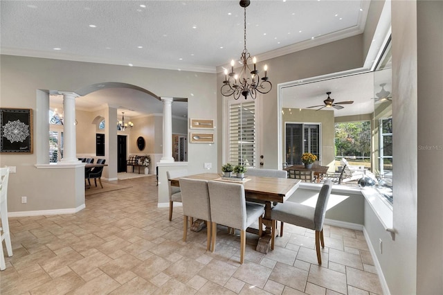 dining area with ceiling fan with notable chandelier, crown molding, and decorative columns