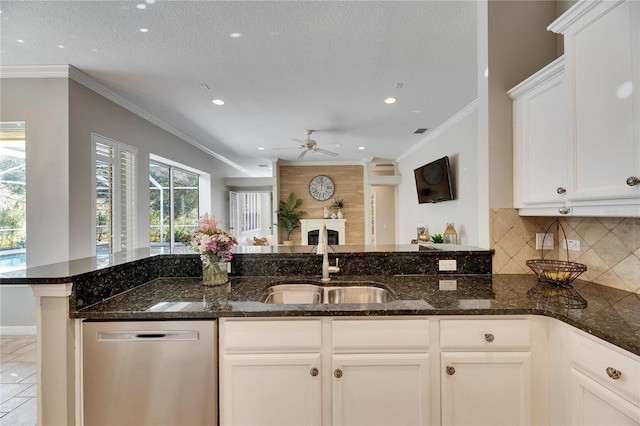 kitchen featuring sink, crown molding, dishwasher, dark stone countertops, and white cabinets