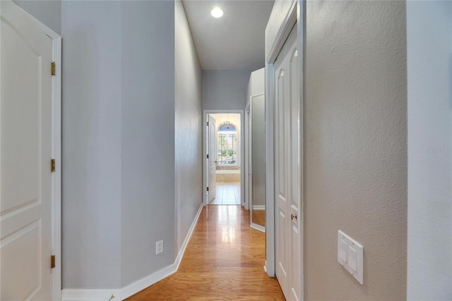 hall with light hardwood / wood-style floors